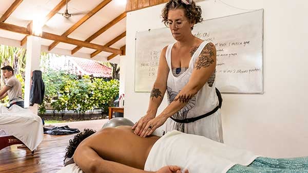 Massage Therapist Giving A Deep Tissue Massage