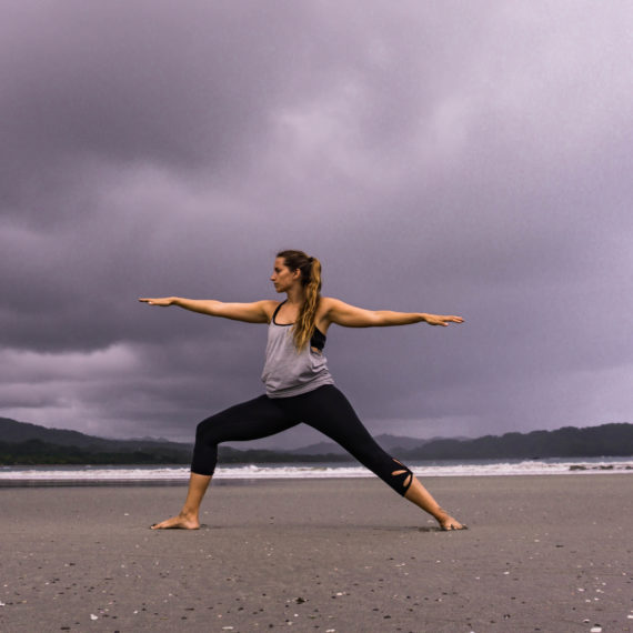 Woman Doing Yoga on the Beach