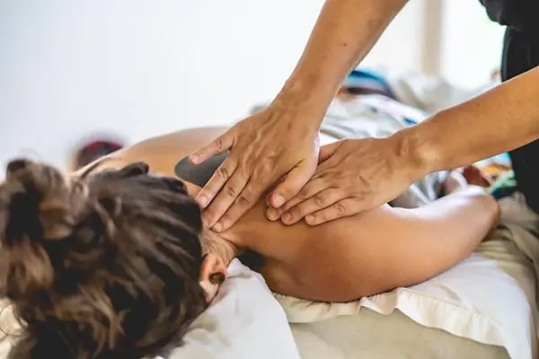 Image of a person giving a soothing back massage