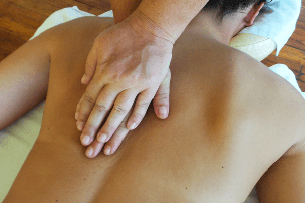 Massage Therapist Hands Giving A Back Massage